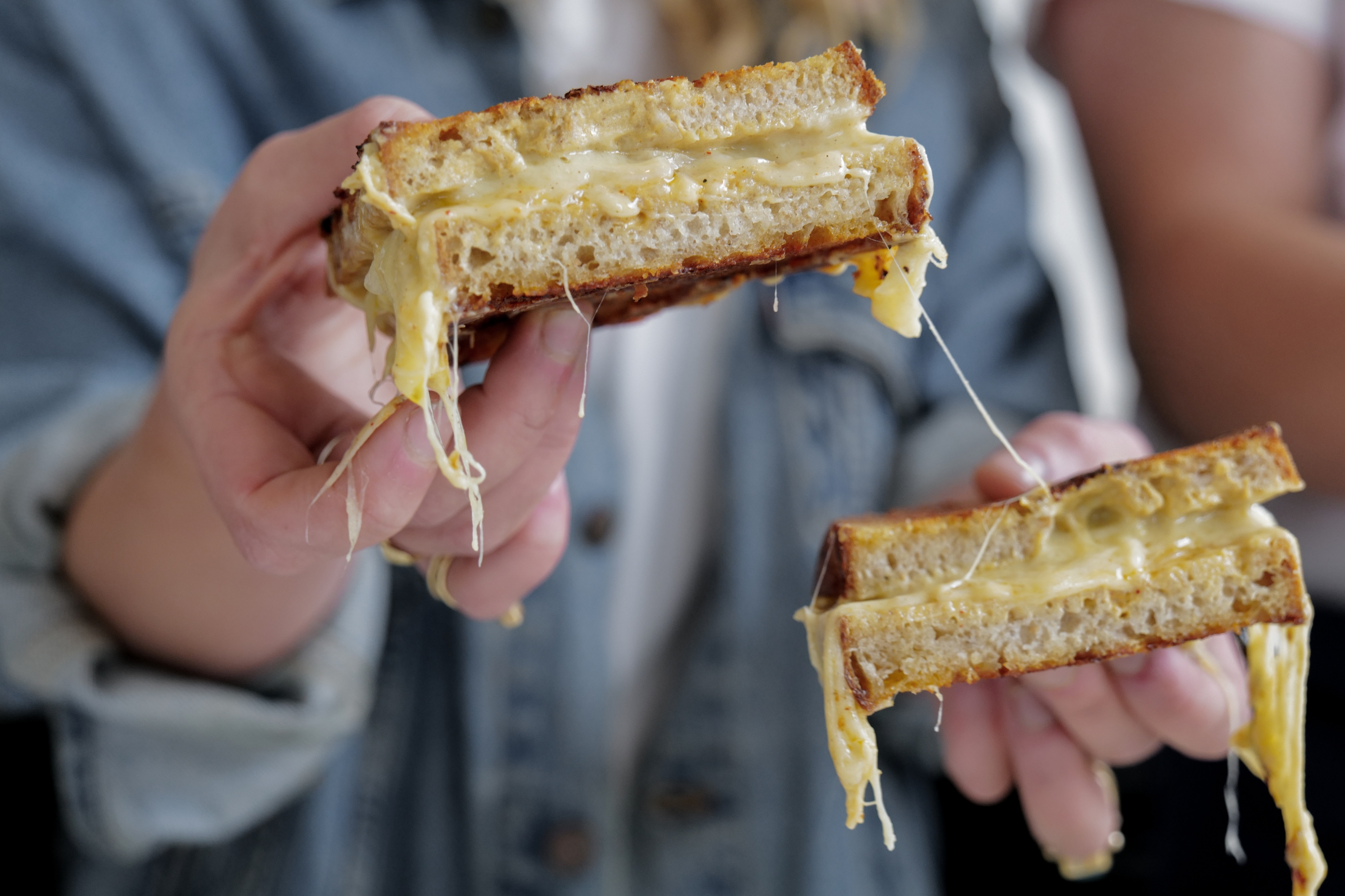Hectors Deli Studd Sibling Toasting Held In Hands Cheese Pull